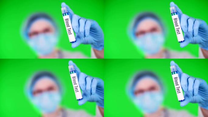 绿色背景。特写镜头，医生的手在蓝色的医疗手套上握着试管，上面刻有血液测试铭文。医生戴着医疗帽，口罩。