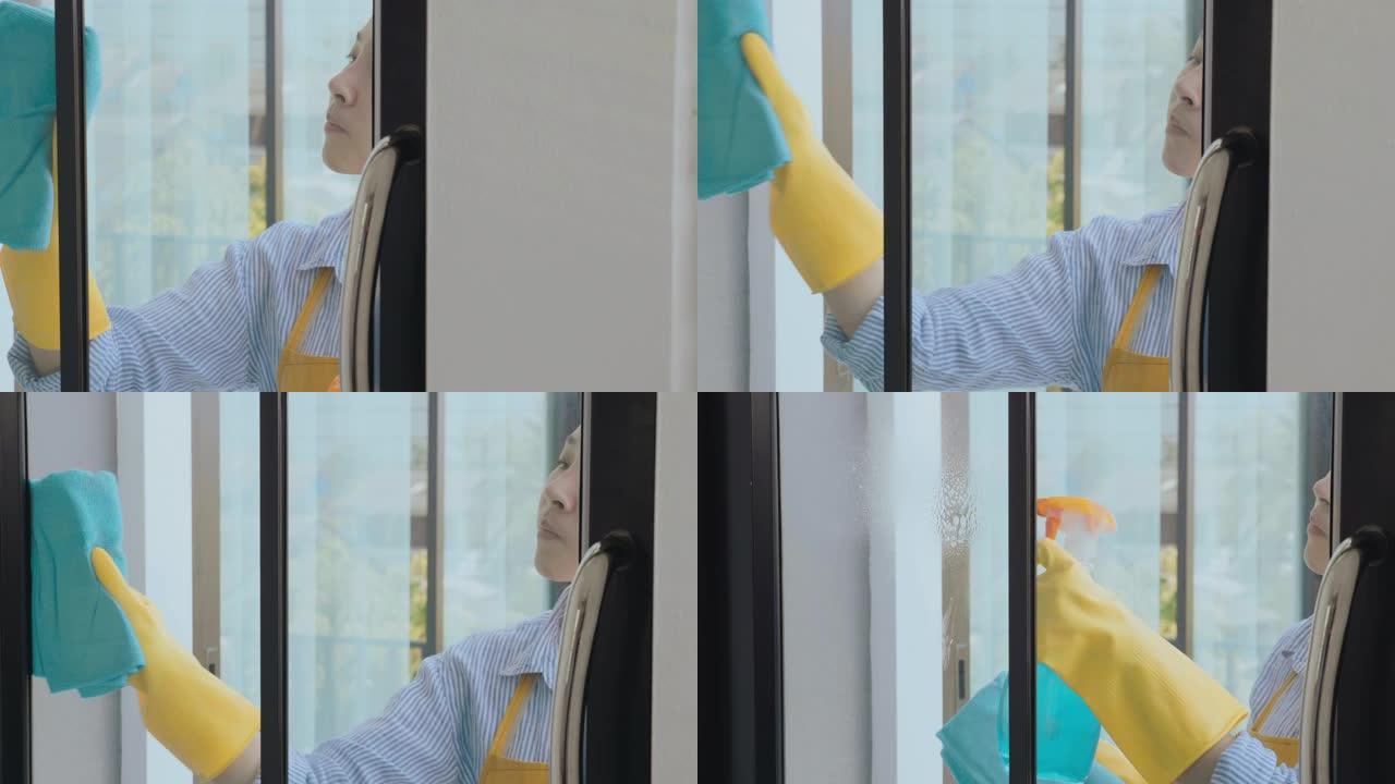 亚洲女性手套清洁溶液喷涂和清洁窗户屋保持概念