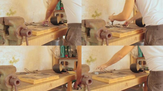 木匠在复古的老式车间里在旧木头上工作。