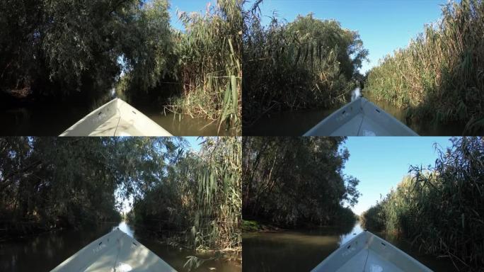 Fishing boat moves along the narrow river