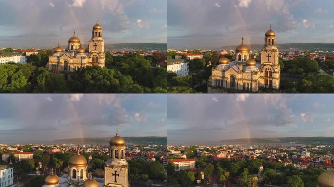 保加利亚瓦尔纳的圣母升天主教座堂和彩色彩虹。空中无人机视图。
