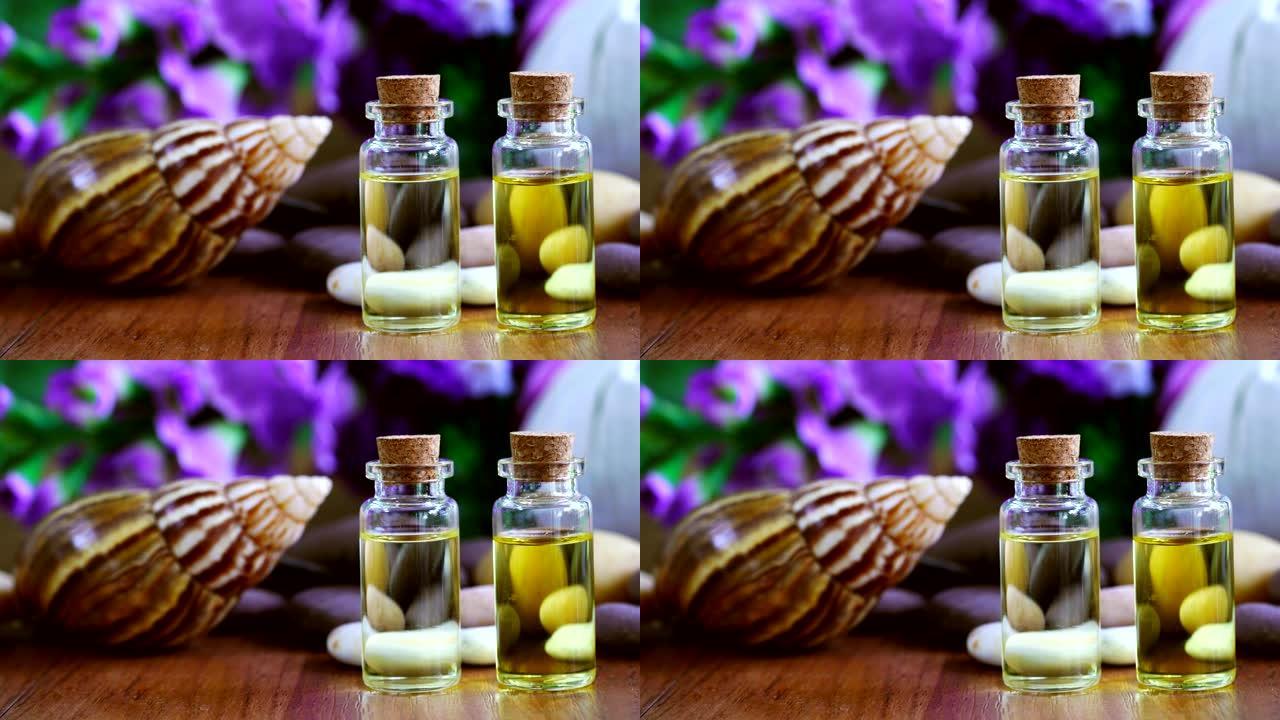 蜗牛和瓶胶原蛋白或血清油与花背景