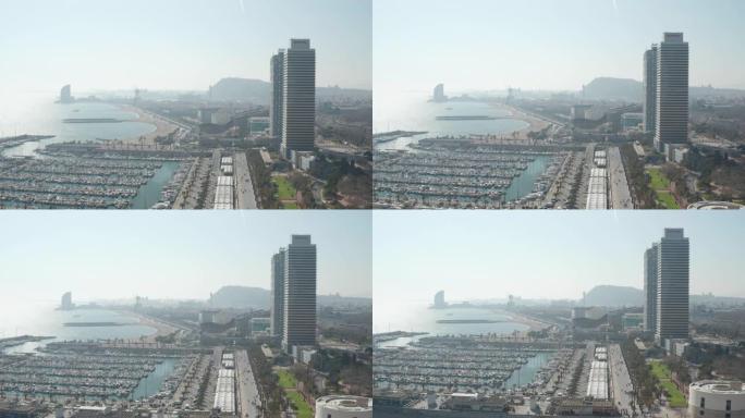 空中: 西班牙巴塞罗那宽无人机拍摄城市和海洋中的船只在海湾 [4K]