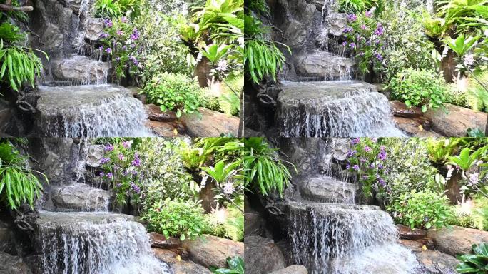 家里花园里的假瀑布石装饰。园艺设计和良好的环境。