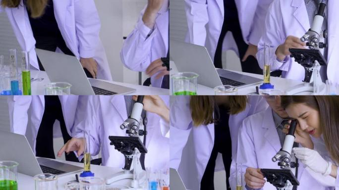 科学家在科学实验室中使用笔记本电脑搜索医学研究信息。科学家使用显微镜来测试和编写测试结果。实验室里有
