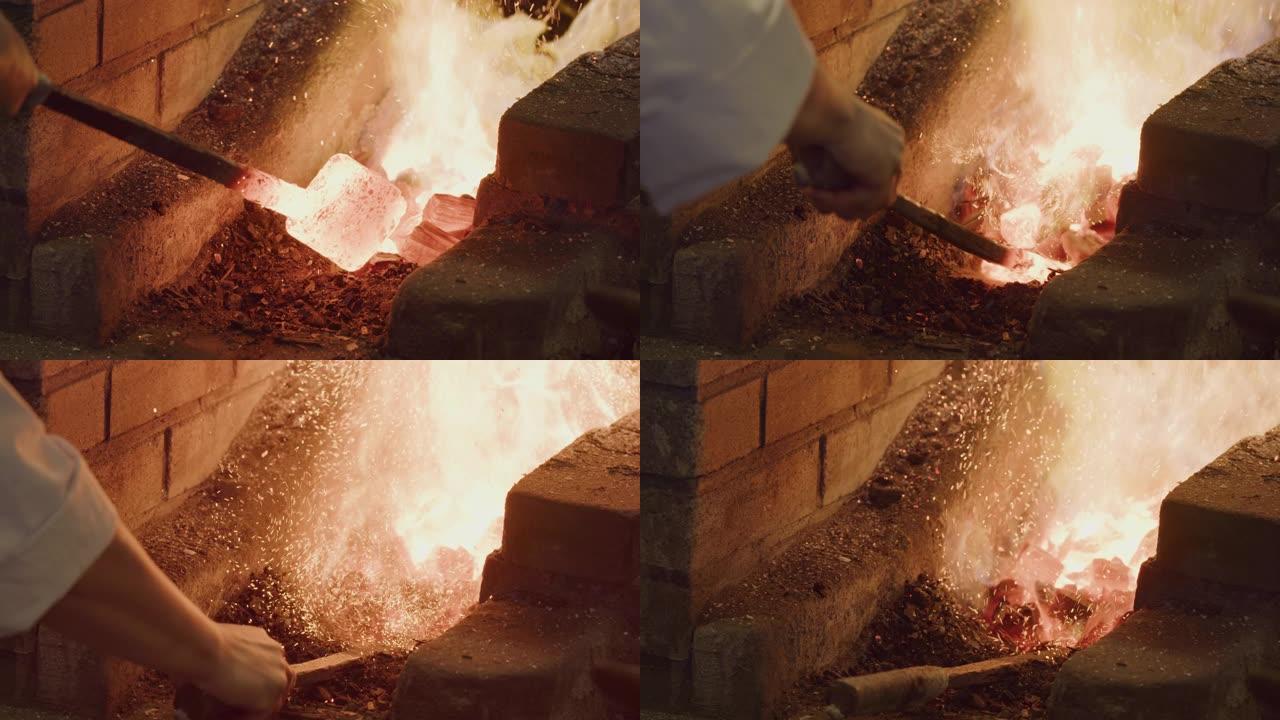 辉光红色的热铸锭位于热的煤炉中。传统铁匠和剑匠。
