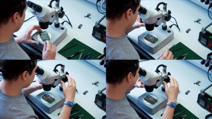 工程师用显微镜将无线接入模块wi-fi放在现场。