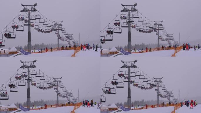 滑雪胜地的滑雪缆车。滑雪者在滑雪椅电梯上爬到下雪坡