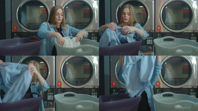年轻女子站在自助洗衣店分类洗衣服。