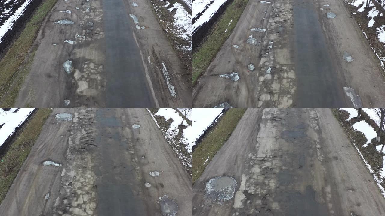 坑洼非常糟糕的道路完全覆盖了表面的缺陷，无人机视图