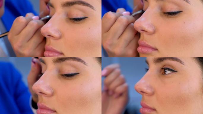 专业化妆师在女孩脸上画眼睑箭头，特写视图。