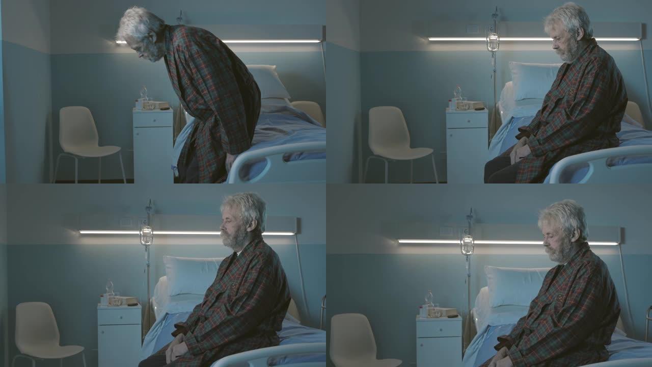悲伤的孤独老人晚上坐在医院的病床上