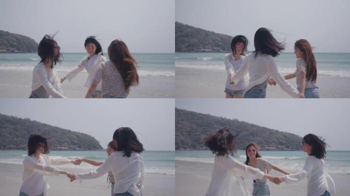 微笑快乐的亚洲朋友一群女人在海滩上手牵着手海边暑假假期旅游享受生活周末活动人们的生活方式，慢动作4k