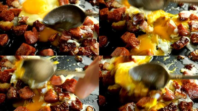 煎蛋或煎蛋卷和切成丁的脆皮香肠和培根在热脂肪中油炸。