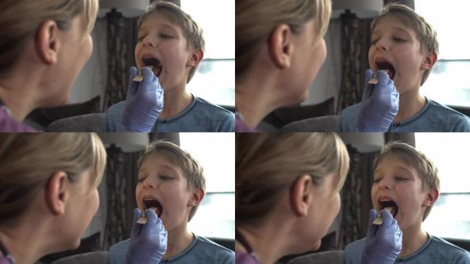 小男孩做喉咙检查外国人少儿看牙齿查牙齿