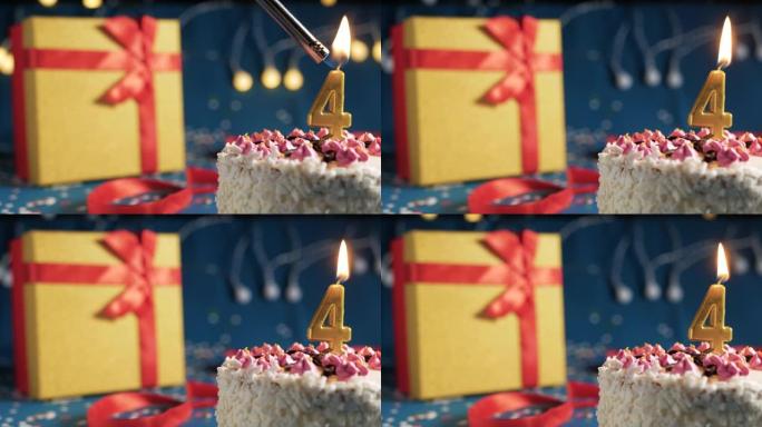 白色生日蛋糕4号点火器燃烧的金色蜡烛，蓝色背景带灯和用红丝带捆绑的礼物黄色盒子。特写
