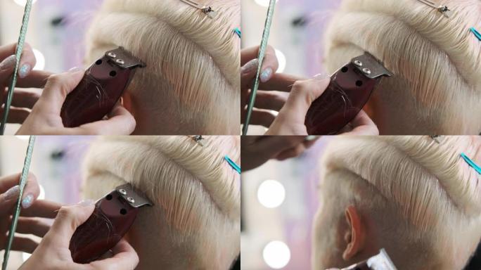 理发师用修剪器剪金发女客户。短小的小精灵发型和剃光的太阳穴。