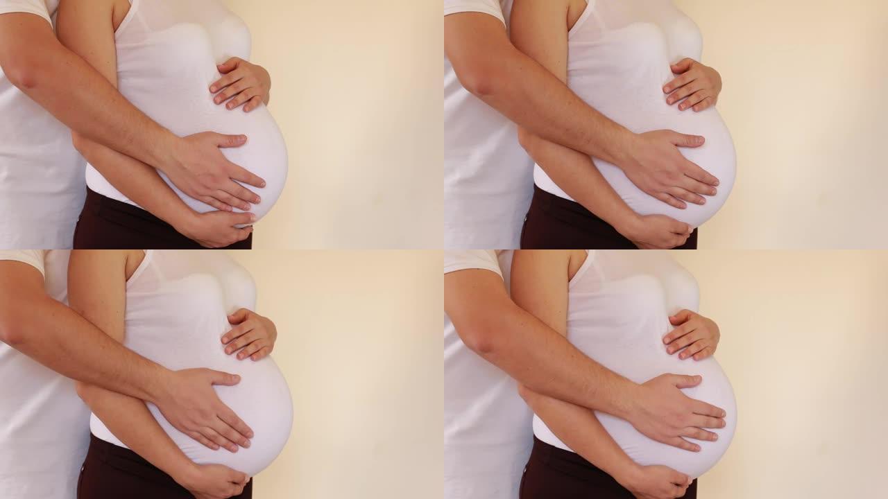 男人抚摸孕妇的肚子