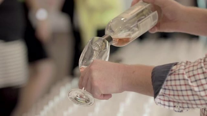 A man pours桃红葡萄酒in a wineglass