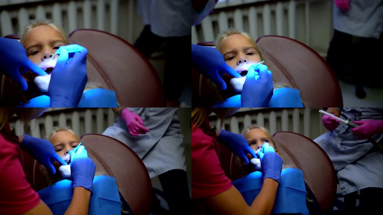 牙医与助理护士和小女孩病人牙科检查