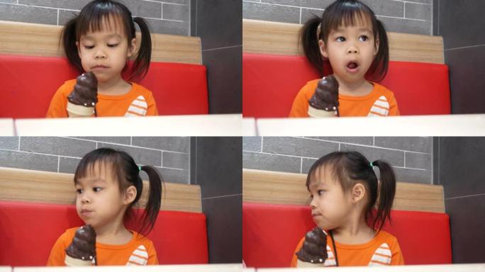 亚洲小女孩喜欢在服务店吃冰尖叫。肯德基是世界著名的美国快餐店。健康理念。