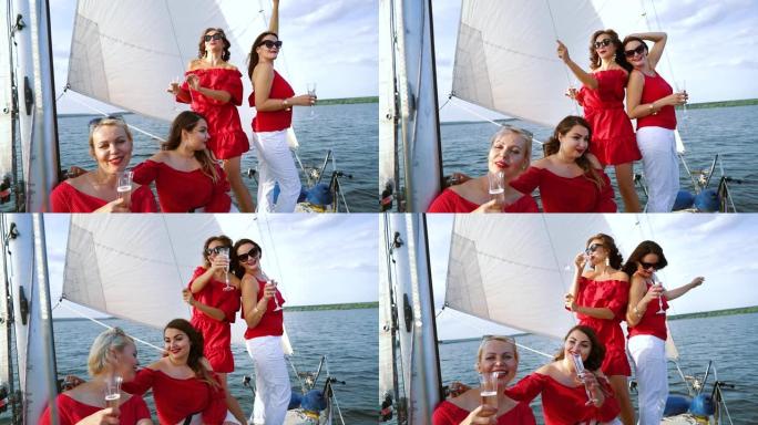 穿着红色夏装的女人在帆船上与酒开派对