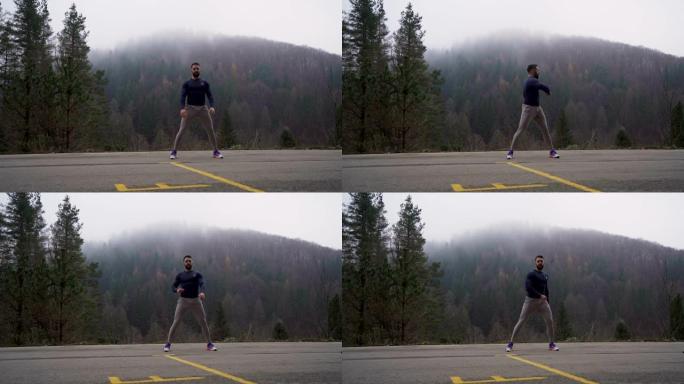 健康强壮男人的前视图。在雾蒙蒙的日子里，男人在户外慢跑前伸展肌肉