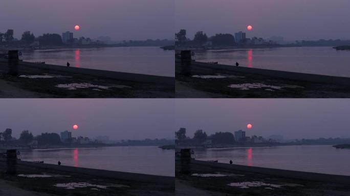 美丽的背景是日落或日出，并在河上反射