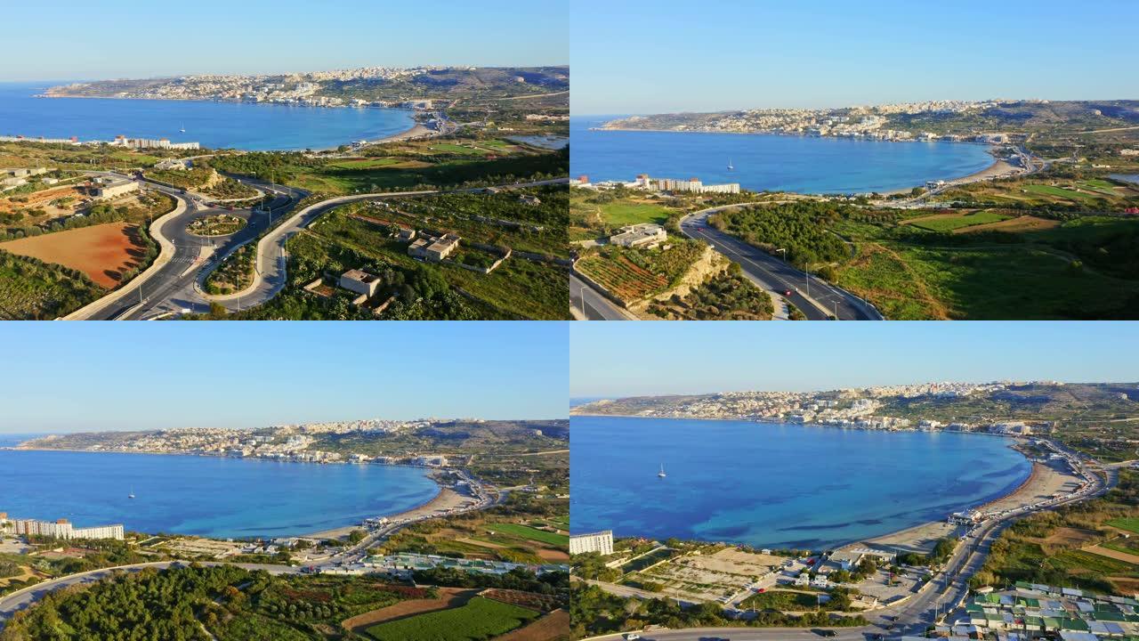 环形交叉路口、海湾、海滩和地中海的空中景观。梅利哈市。摄像机向前移动。马耳他国家