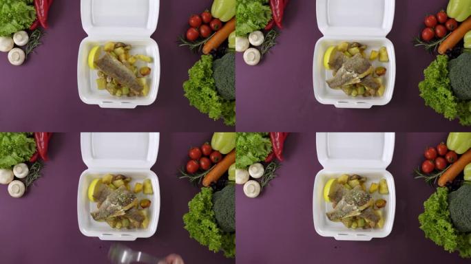 将外卖食品包装在聚苯乙烯泡沫塑料盒中。新鲜送餐搭配鱼和土豆