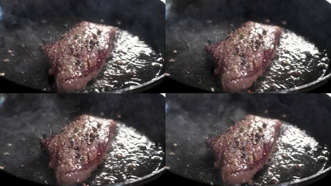 大理石胡迪尼多汁令人垂涎的牛排。用平底锅和橄榄油油炸。沸腾的油和大量蒸汽飞溅。