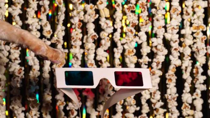 猫爪玩3D眼镜。爆米花和金色闪闪发光的金属丝花环的散焦动态背景。漫画新闻，搞笑娱乐，好玩。4k视频