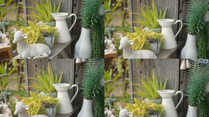 美丽的复古装饰和花园植物。一套复古风格的花瓶和陶瓷人物，用于庭院装饰。现代时尚背景。