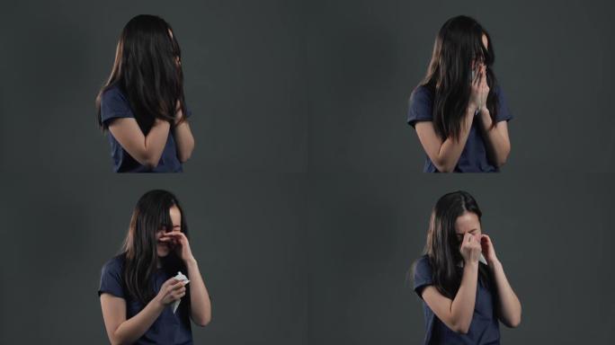 年轻的亚洲女孩打喷嚏成组织。灰色工作室背景上的孤立女性生病，有感冒或过敏反应。冠状病毒，流行病202