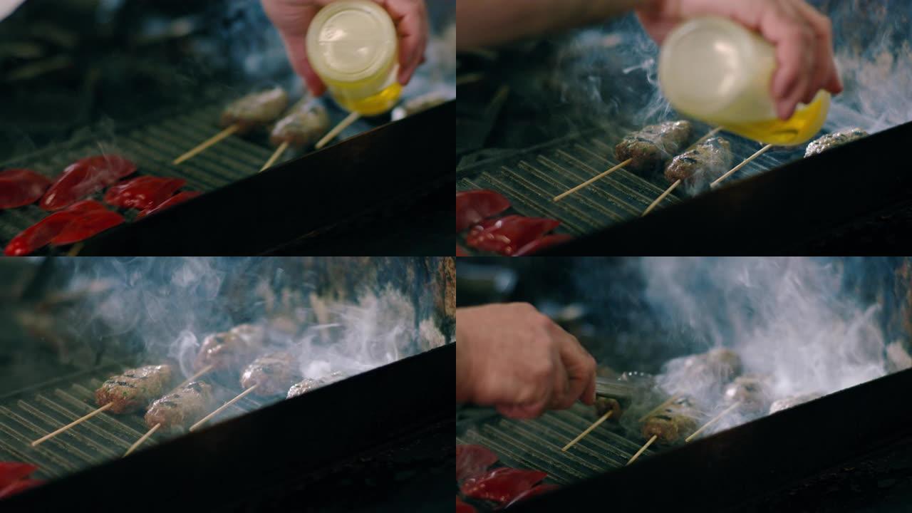 厨师在烧烤上烧烤羊肉串