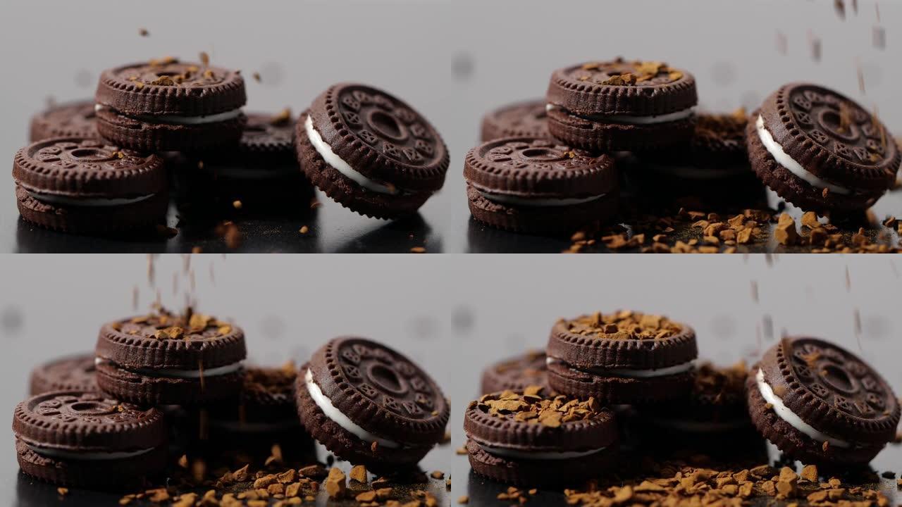 在黑暗背景下慢动作的巧克力片落入饼干和奶油中的特写镜头