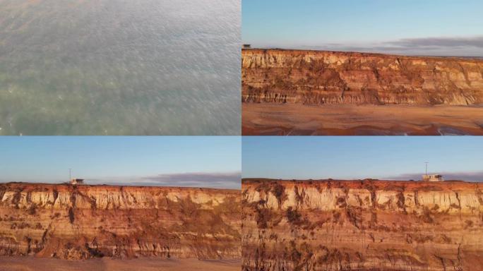 空中侧面 (从右到左) 显示了Hengistbury Head悬崖的镜头，其中包括救生员站，美丽的沙