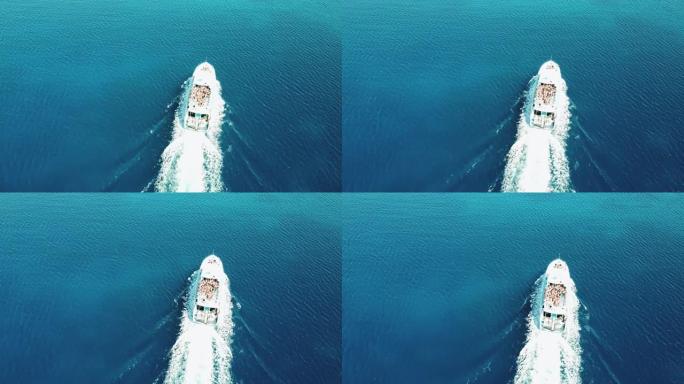 从上方拍摄蓝色大海中的白色游艇，人群在船上跳舞，俯视图，无人机射击