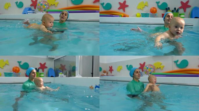 母亲帮助婴儿在儿童游泳池游泳，并用双手在水中支撑婴儿。他们玩耍和大笑。游泳训练。婴儿游泳。特写