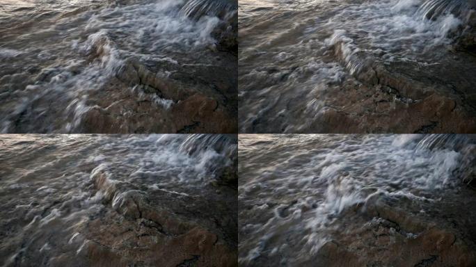Water flowing into limestone travertines of pamukk