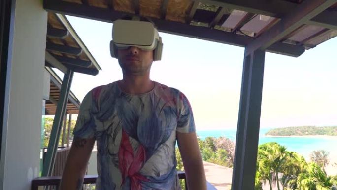 阳台上戴3D VR眼镜的年轻人