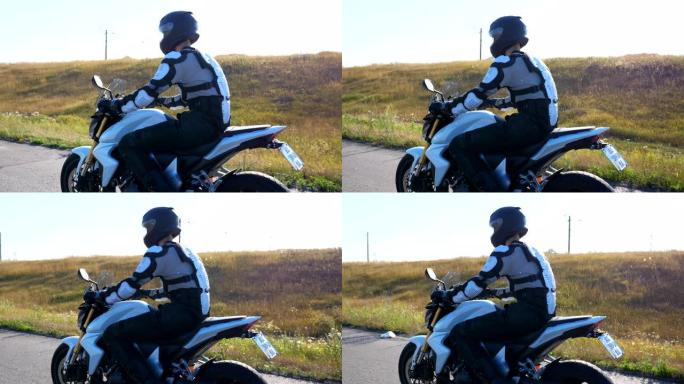 戴着头盔的男子在高速公路上骑着强大的运动摩托车。摩托车手在乡间小路上骑摩托车。骑摩托车的人在旅行中骑