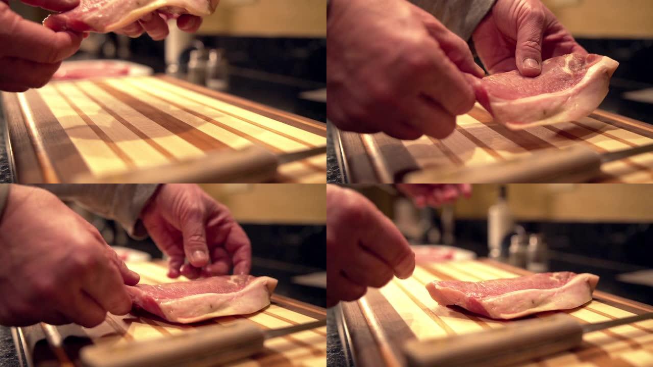 在准备烧烤的木制切菜板上放下新鲜未煮过的生去骨里脊肉猪排的特写慢动作镜头