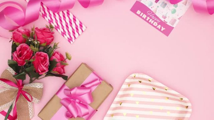 粉色浪漫花朵，粉色背景上有礼物和庆典或周年纪念配件-停止运动