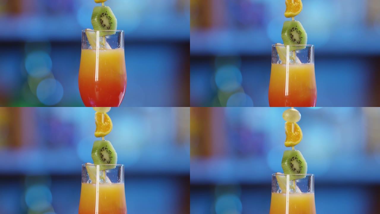 4K专业调酒师用水果装饰冷饮。调酒师准备鸡尾酒在散焦背景和倒和服务的鸡尾酒。调酒师准备五颜六色的鸡尾