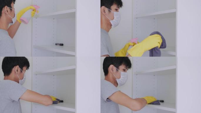 亚洲男子戴黄色手套清洁和消毒屋内新型冠状病毒肺炎病毒