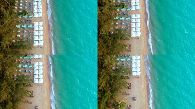 海边白沙滩伞的鸟瞰图