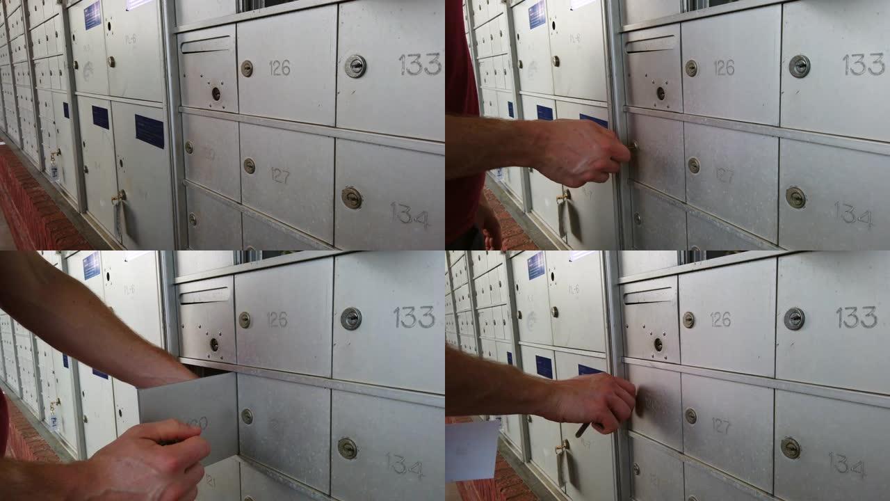 公寓住宅开发中的一个邮箱单元用白人男性的手慢动作拍摄。