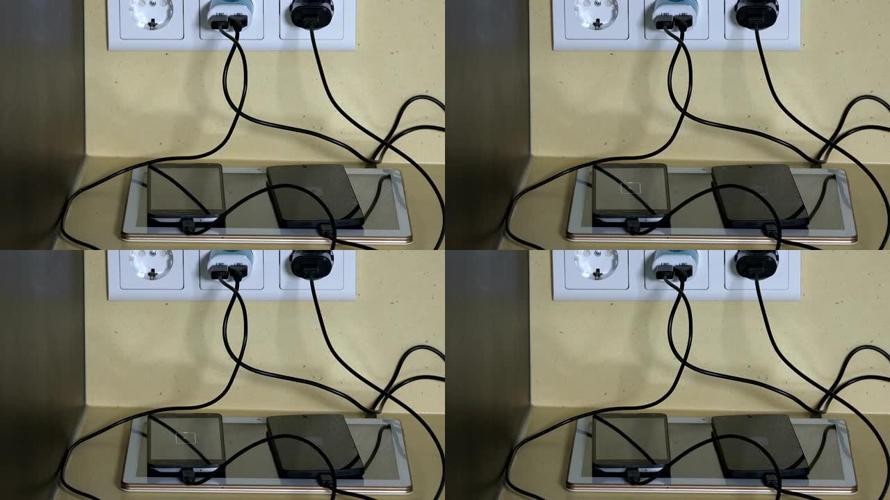 男性双手将微型usb电缆连接到智能手机和平板电脑充电