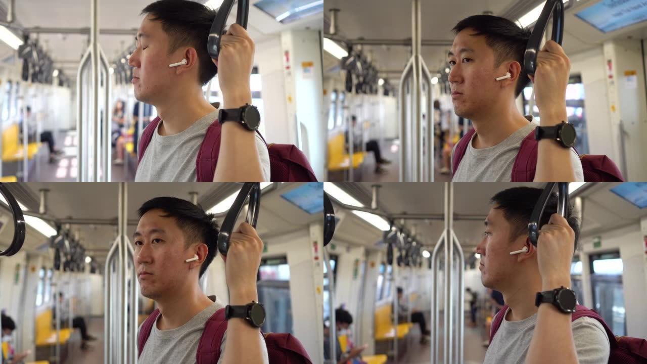 年轻人坐火车通勤时用无线耳机听音乐的特写镜头。享受音乐的亚洲人